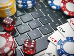 casino-online-gambling-chips-cards-and-dice-on-laptop-computer-background-3d-illustration