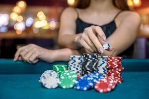female-hand-taking-poker-chips