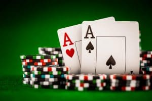 stack-of-chips-and-two-aces-on-the-table-on-the-green-baize-poker-game-concept